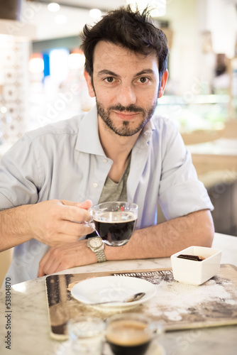 man at the bar drinking coffee