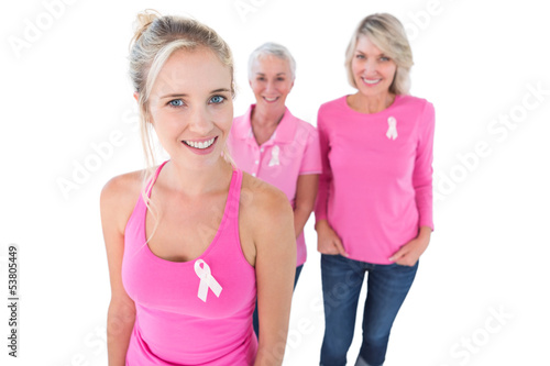 Three generations of women wearing pink tops and breast cancer r
