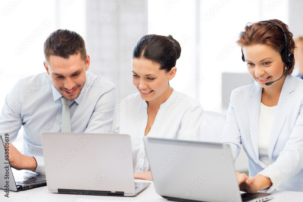 group of people working with laptops in office group of people working with laptops in office