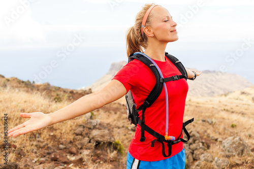 Young woman runner in mountains