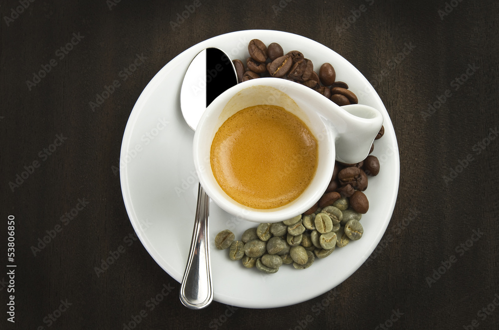 cup of coffee and beans on a wood table cup of coffee and beans on a wood table