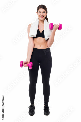 Fitness female instructor lifting dumbbells