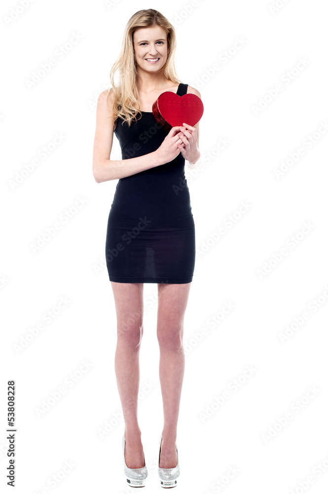 Tall attractive girl holding heart shaped gift Tall attractive girl holding heart shaped gift