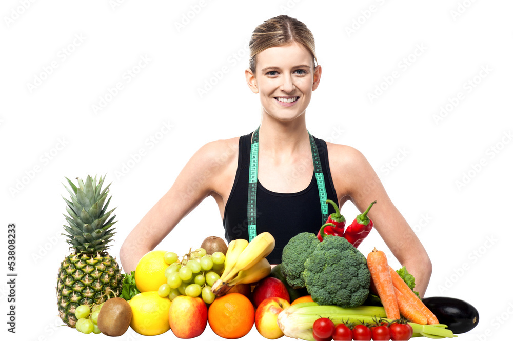 Slim fit girl with fresh fruits and vegetables Slim fit girl with fresh fruits and vegetables