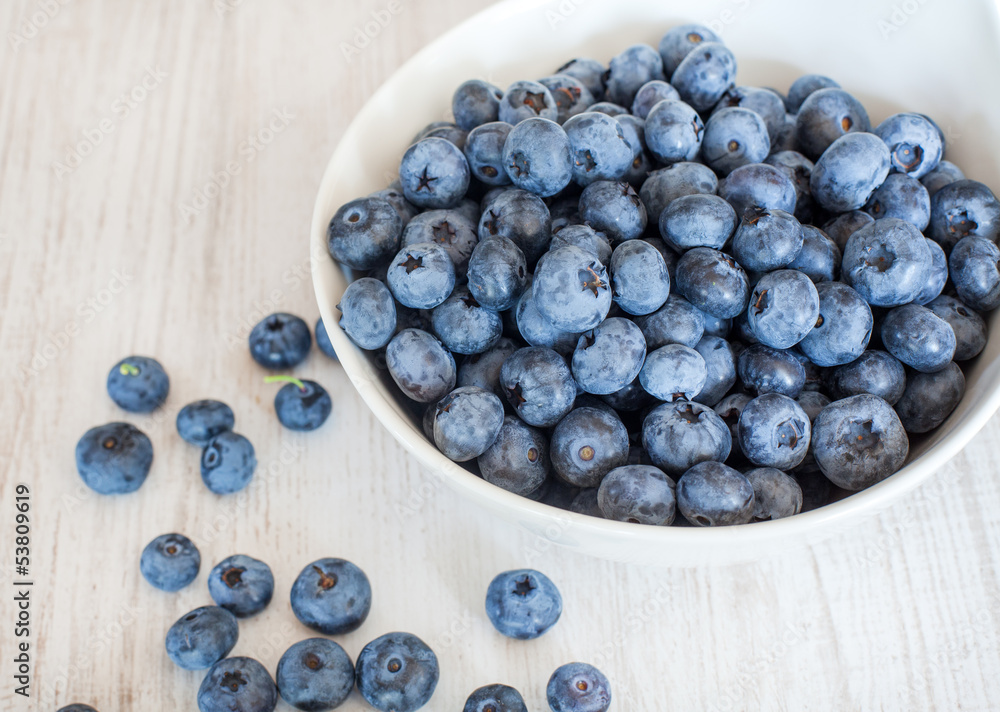 White bowl cup with fresh ripe blueberries White bowl cup with fresh ripe blueberries