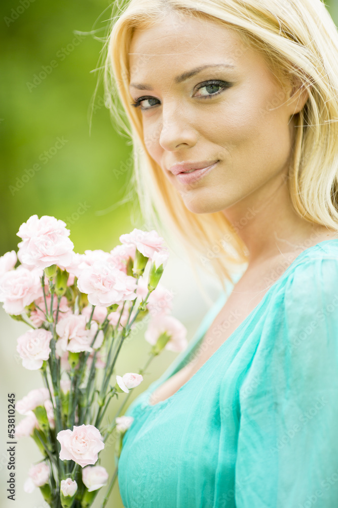 Young blond woman with flowers Young blond woman with flowers
