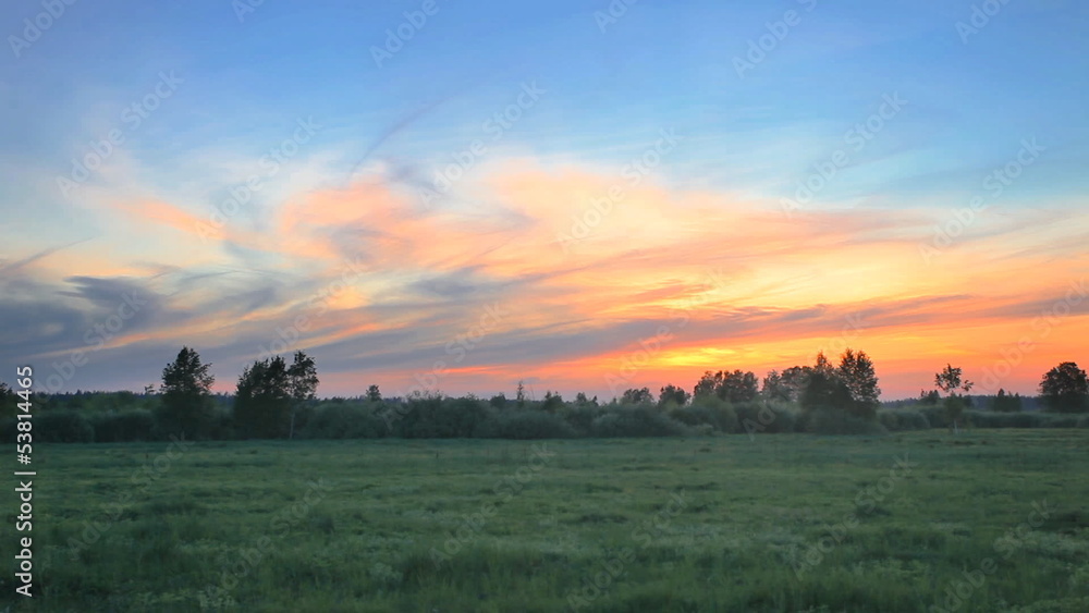 Gloomy sunset with dramatic sky over green field. Gloomy sunset with dramatic sky over green field.