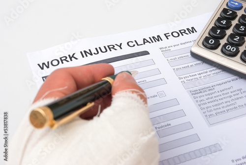 filling up a work injury claim form photo