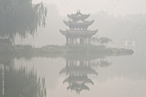 A chinese pavilion under the fog