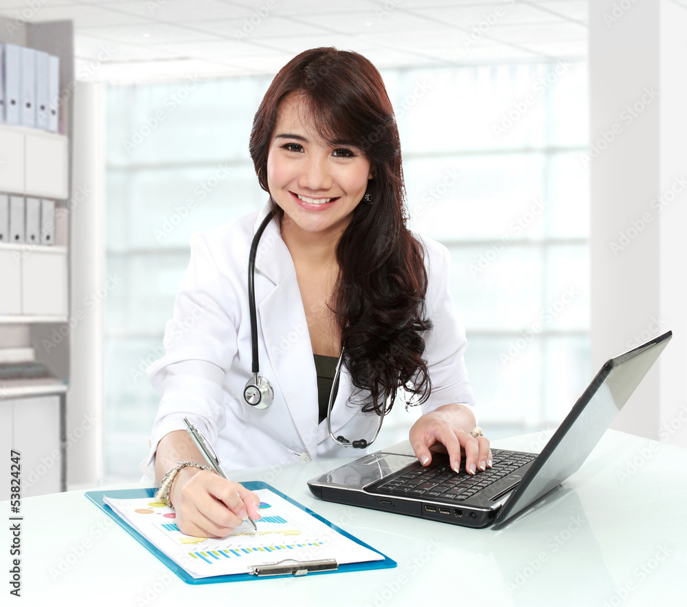 smiling doctor female working in her office smiling doctor female working in her office