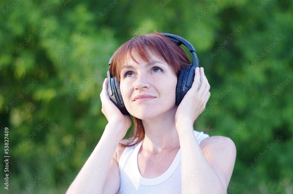 happy woman outdoors in wireless headset happy woman outdoors in wireless headset