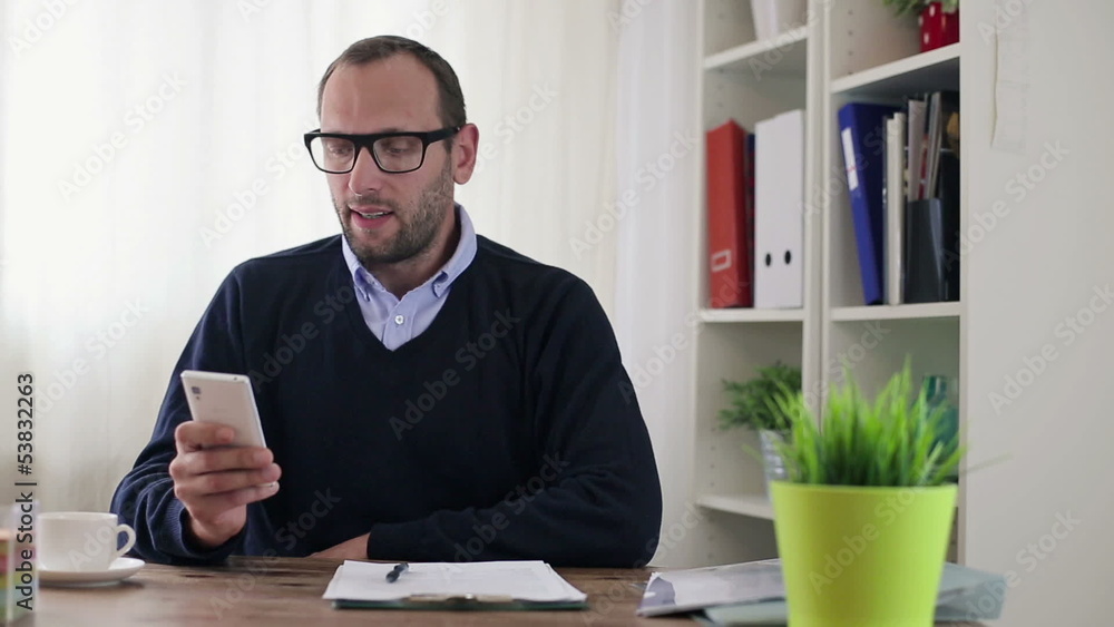 Businessman with smartphone in the office Businessman with smartphone in the office