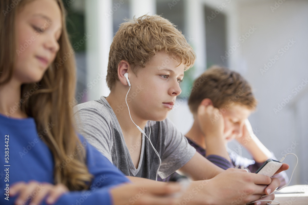 Students using electronic gadget in a classroom Students using electronic gadget in a classroom