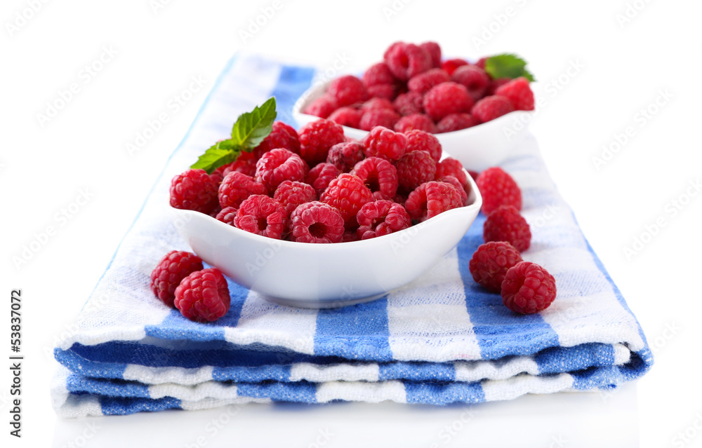 Ripe sweet raspberries in bowls, isolated on white Ripe sweet raspberries in bowls, isolated on white