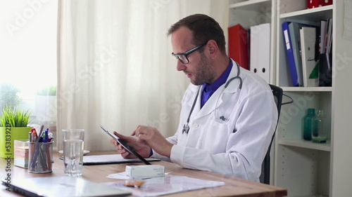 Male doctor with tablet computer in office