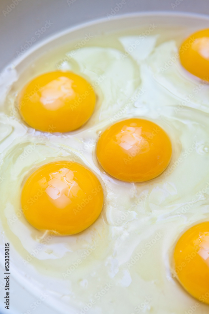 Crude protein and egg yolk in a frying pan Crude protein and egg yolk in a frying pan