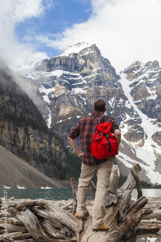 Hiking Man Looking at Moraine Lake & Rocky Mountains photo