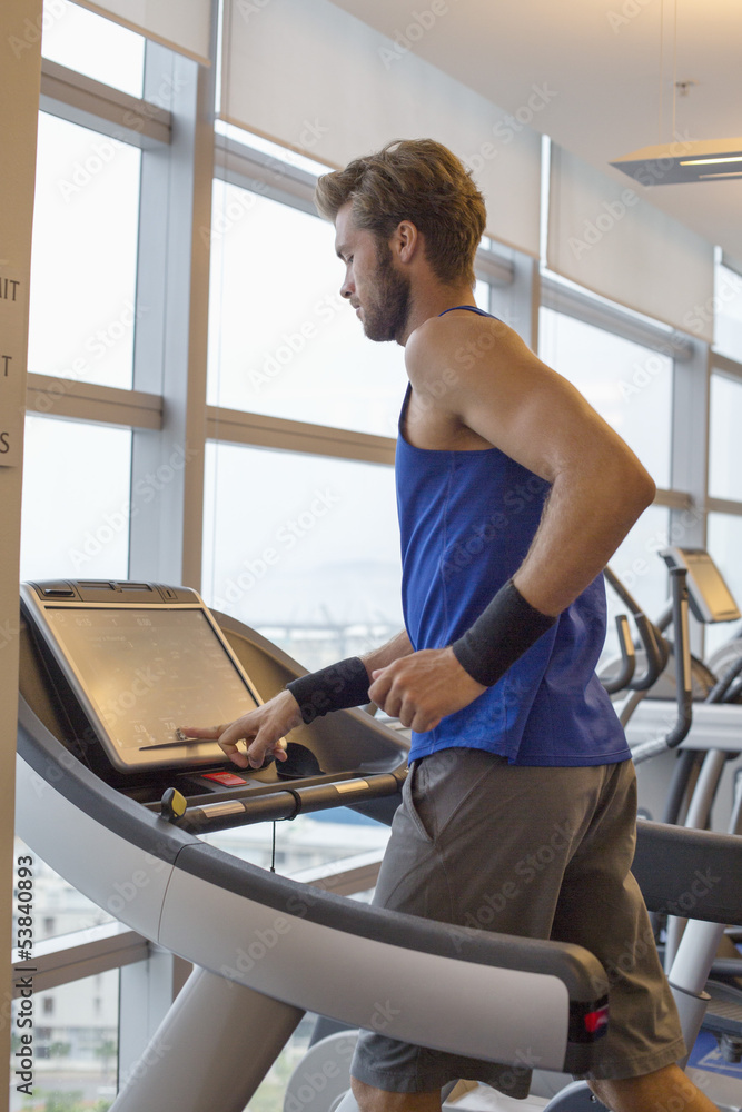 Man running on a treadmill in a gym Man running on a treadmill in a gym