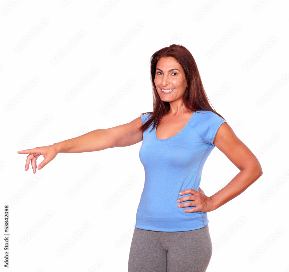 Sporty adult woman in gym clothing pointing right Sporty adult woman in gym clothing pointing right