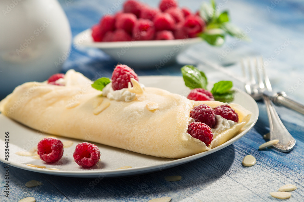 Raspberry pancakes served with whipped cream Raspberry pancakes served with whipped cream