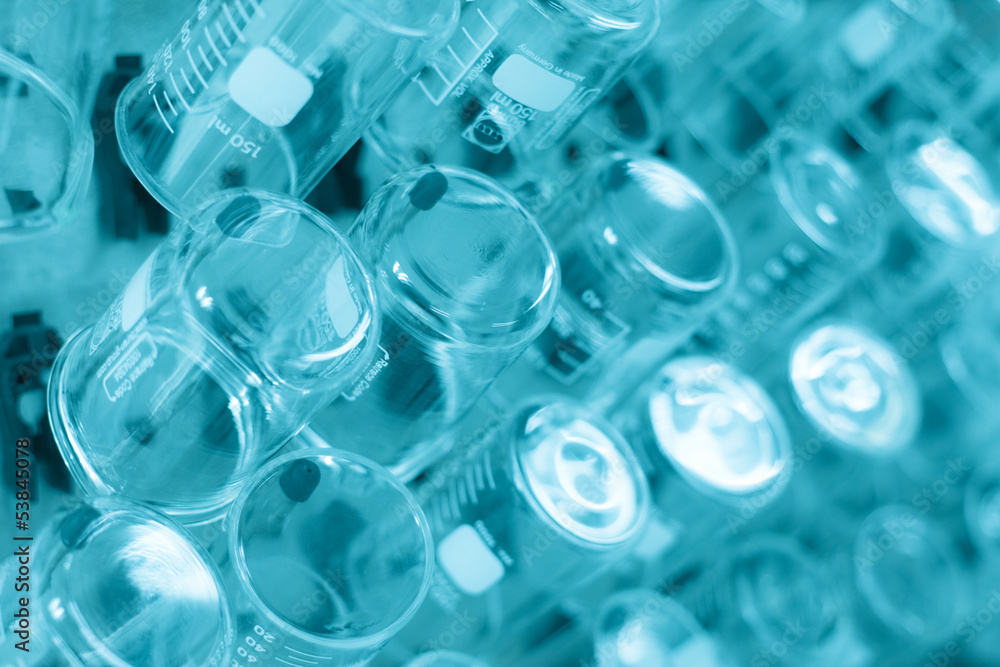 Rows of beaker on a drying rack in a chemistry lab. Rows of beaker on a drying rack in a chemistry lab.