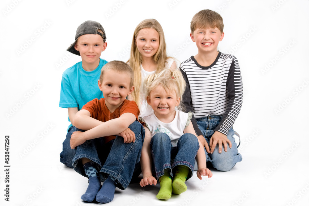The group of five children siting on the floor The group of five children siting on the floor