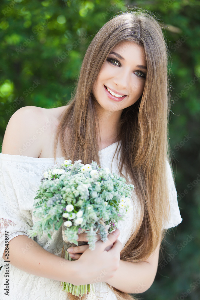 Young woman in the park with flowers Young woman in the park with flowers