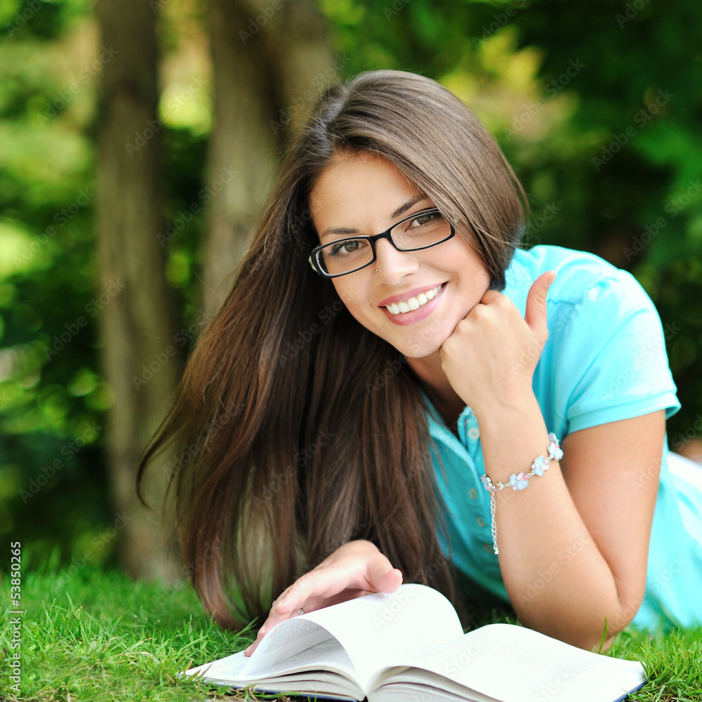 Young beautiful girl reading book in a summer green park Young beautiful girl reading book in a summer green park