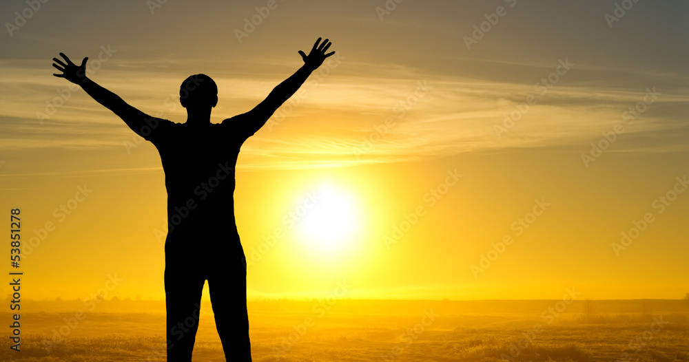 Fototapeta premium Silhouette of man on the field in the morning at sunrice