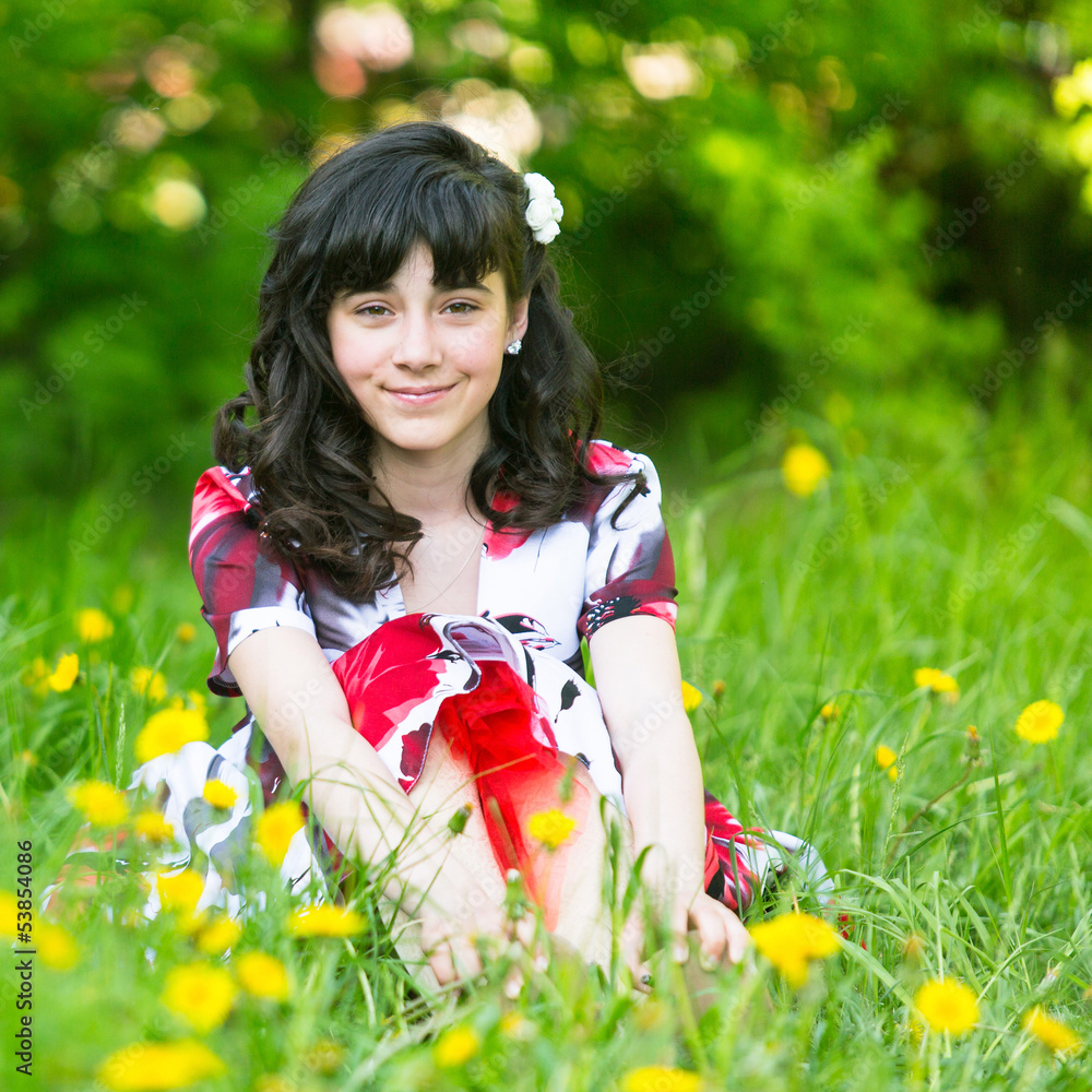 A young pretty girl sitting in the grass A young pretty girl sitting in the grass