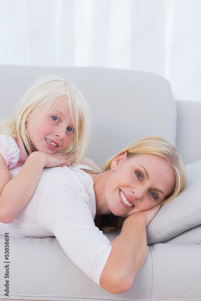 Mother with her daughter lying on couch Mother with her daughter lying on couch