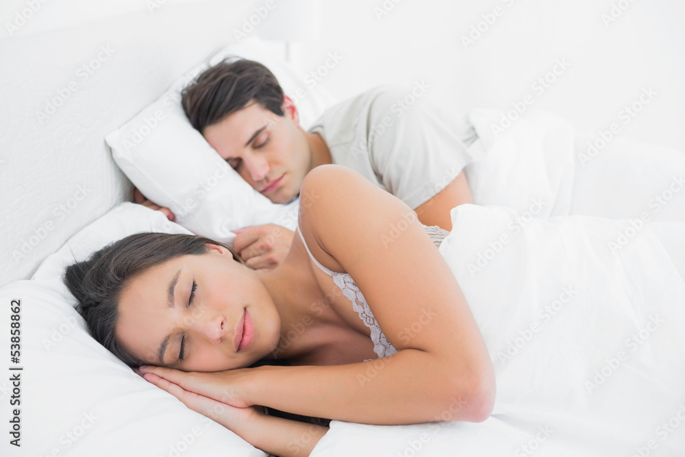 Pretty woman sleeping next to her partner Pretty woman sleeping next to her partner