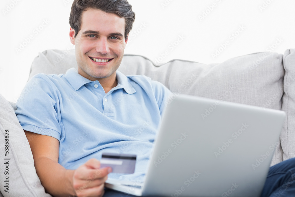 Portrait of a man using his credit card to purchase online Portrait of a man using his credit card to purchase online