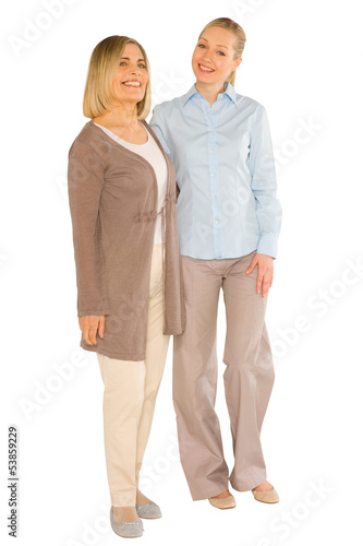 smiley grandmother and young mother standing on white background