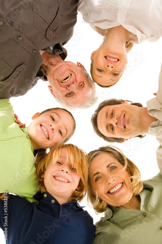 three generations family looking at camera isolated on white bac