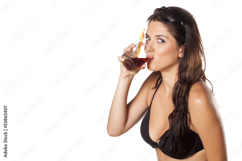 brunette in a swimsuit and sunglasses drinking her cocktail brunette in a swimsuit and sunglasses drinking her cocktail