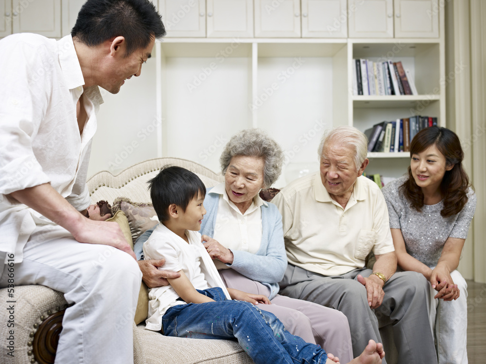 asian family gathering and talking in living room asian family gathering and talking in living room