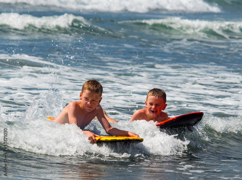 Photos Two boys playing in surf