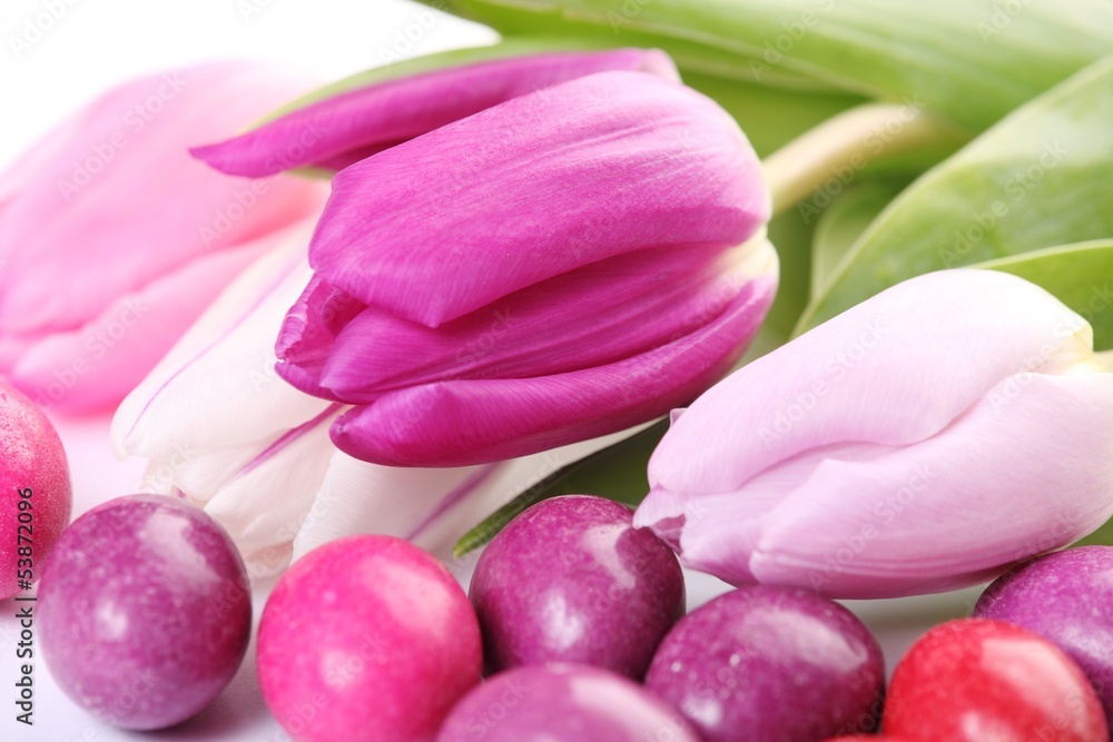 Fototapeta premium Close-up of chocolate eggs and tulips.