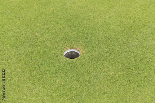 Golf hole on green grass