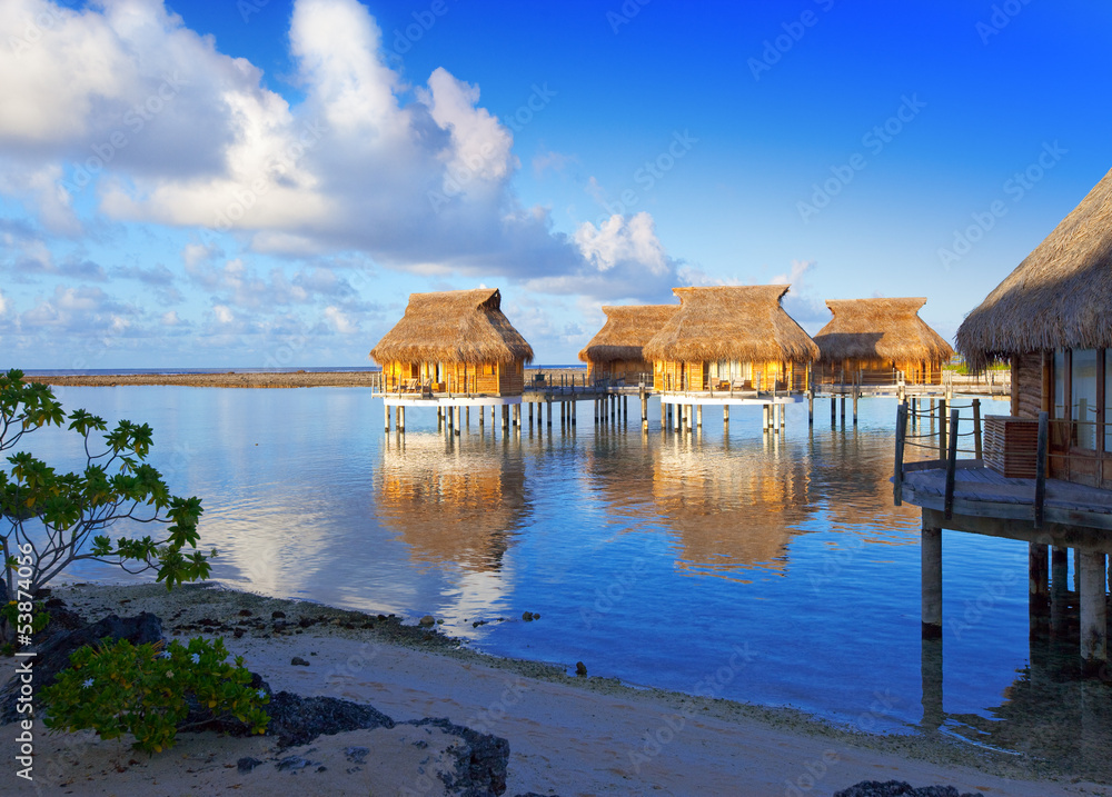 The coast and lodges on water at sunrise