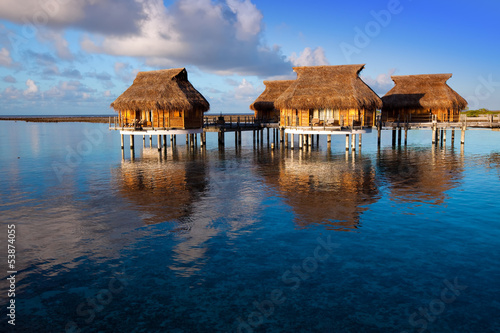 houses over the transparent quiet sea water  on a sunset