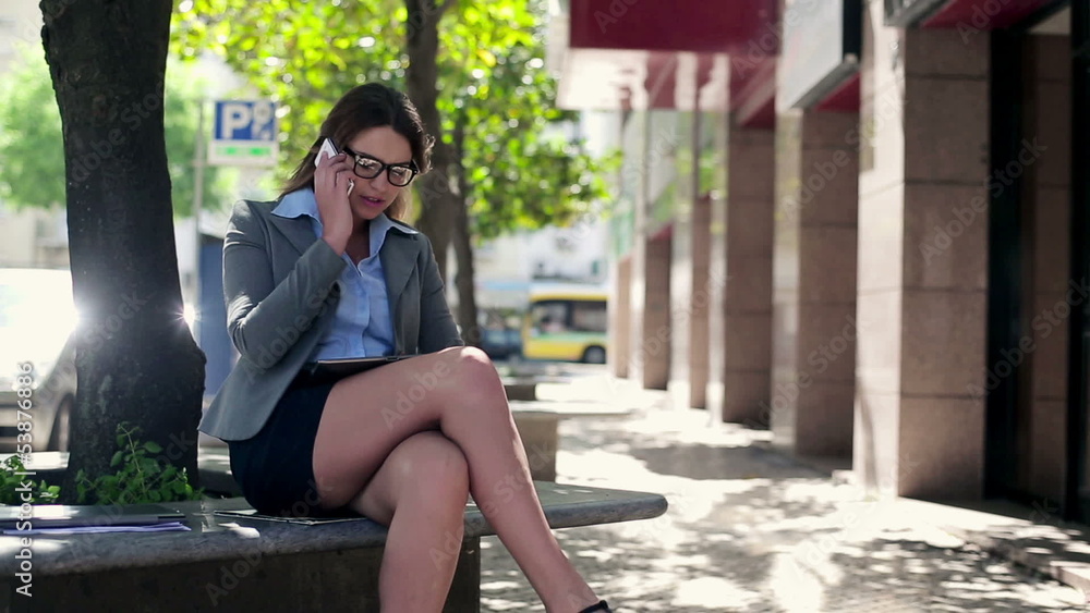 Young businesswoman with tablet and cellphone in the city Young businesswoman with tablet and cellphone in the city
