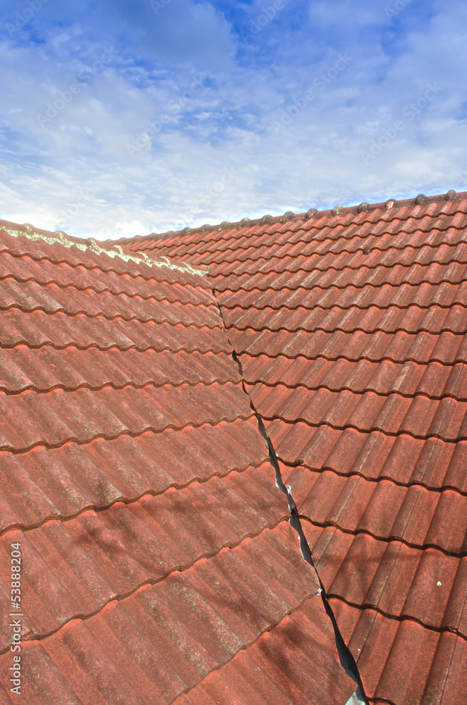 Naklejka premium Tiled Roof with Fluffy Cloud Blue Sky