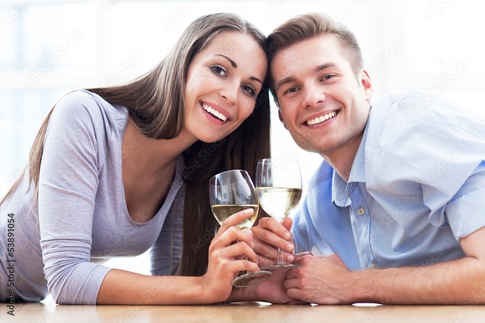 Couple on floor drinking wine Couple on floor drinking wine