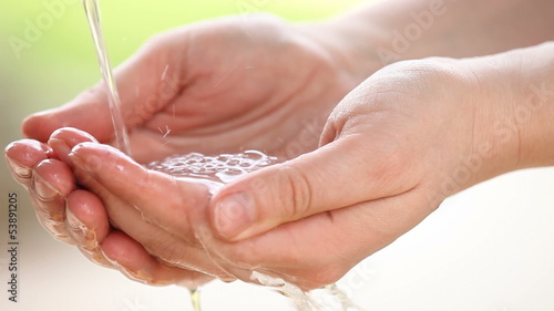 Close-up of hands and pouring water