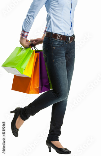 Woman hiding multicolored shopping paper bags