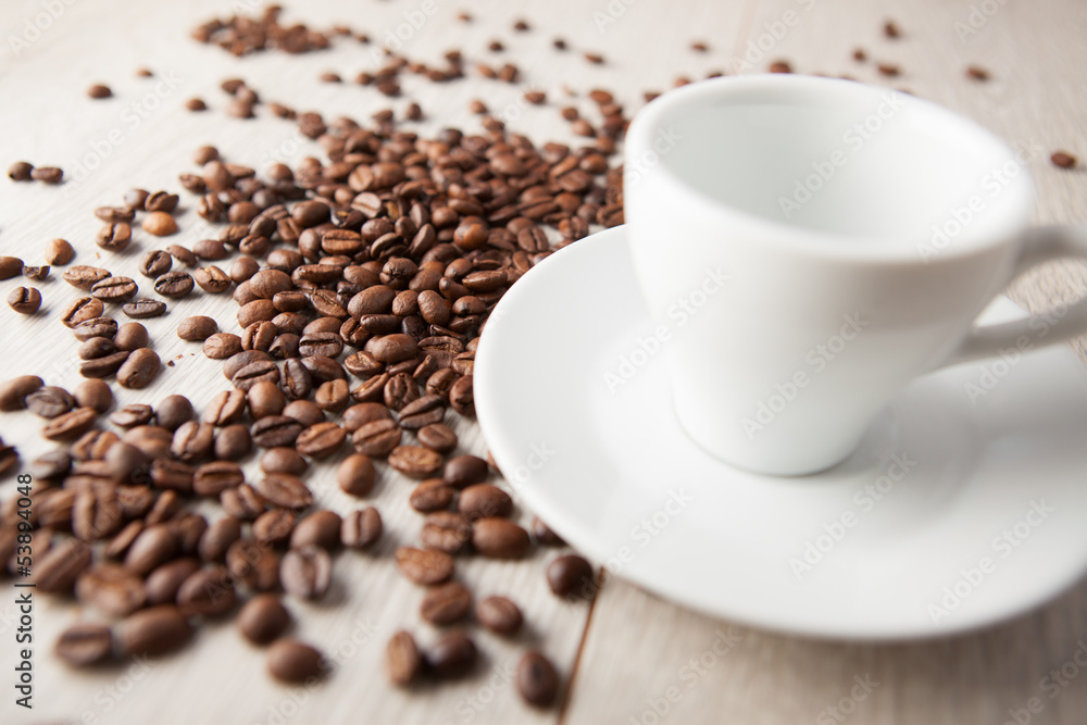 empty coffee cup with scattered beans empty coffee cup with scattered beans