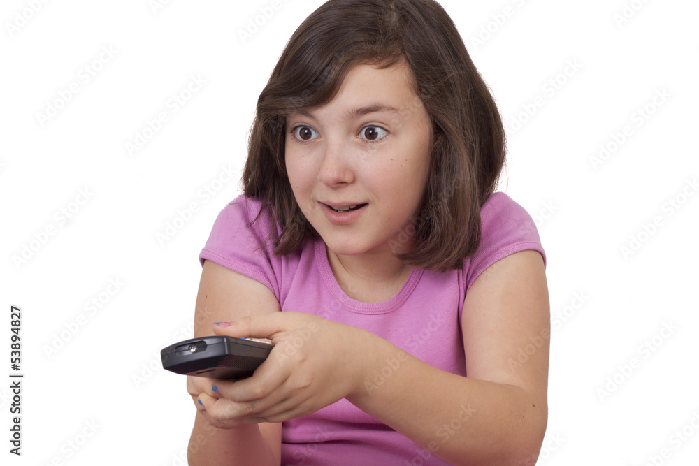 Beautiful teenage girl with tv remote control in her hands Beautiful teenage girl with tv remote control in her hands