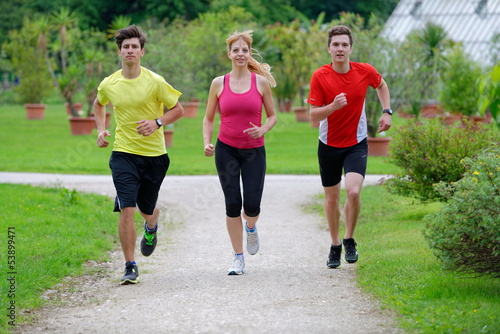 Three athletes jogging in the park